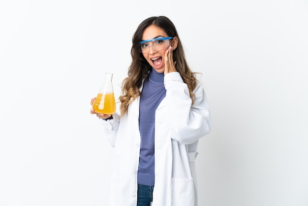 Young scientific woman on white background with surprise and shocked facial expression