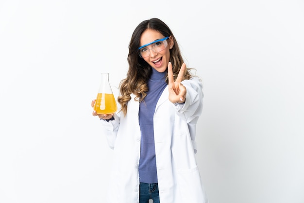 Young scientific woman on white smiling and showing victory sign