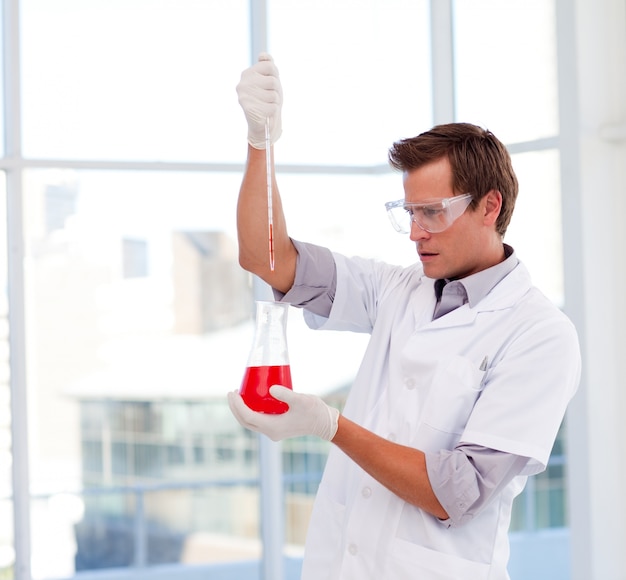 Young scientist examinig a test-tube