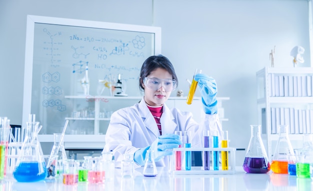 Young scientist looking through a tube in a laboratory