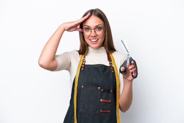 Young seamstress woman isolated on white background with surprise expression