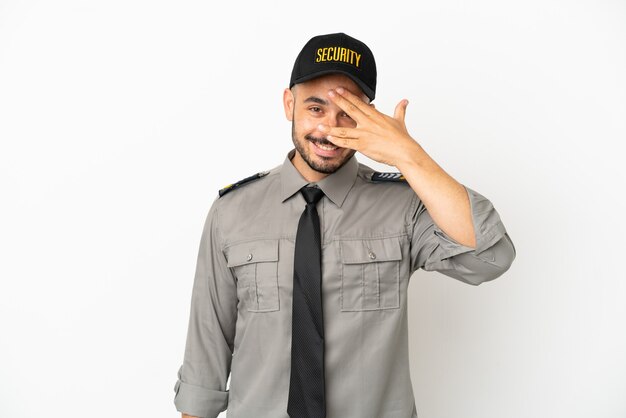 Young security  caucasian man isolated on white background covering eyes by hands and smiling