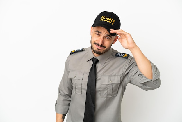 Young security  caucasian man isolated on white background looking far away with hand to look something