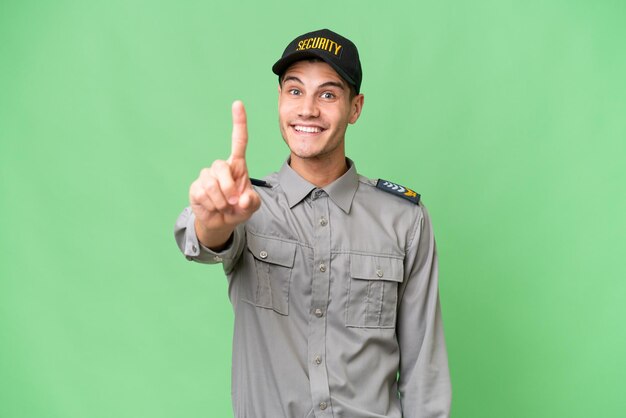 Young security man over isolated background showing and lifting a finger