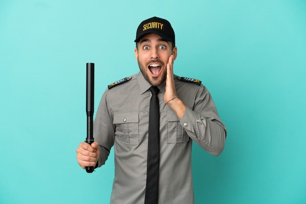 Young security man isolated on blue background with surprise and shocked facial expression