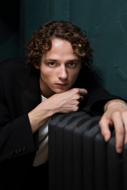 Young sensitive man posing with radiator