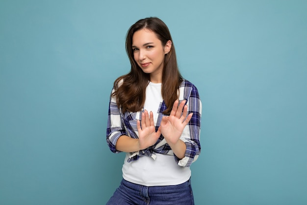 Young serious dissatisfied   woman with sincere emotions wearing trendy check shirt