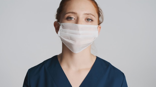 Young serious doctor in medical mask