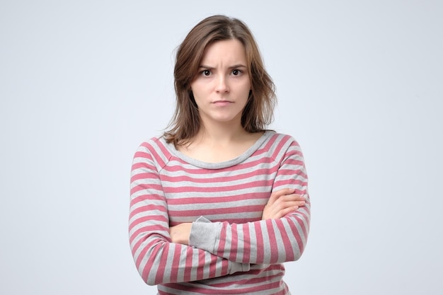 young serious european woman portrait looking with irritation at camera