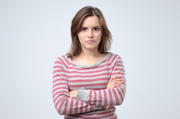 Young serious european woman portrait looking with irritation at camera