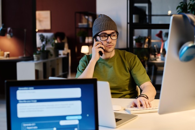 Photo young serious male ai designer at work