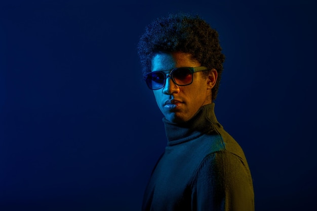 Young serious man in eyeglasses studio headshot