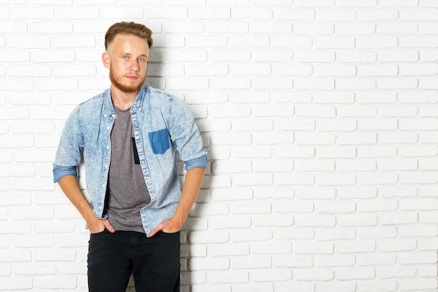 Young Sexy Man Against a White Brick Wall