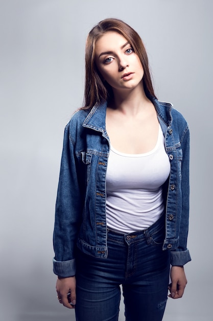 Young sexy woman in jeans jacket, white shirt