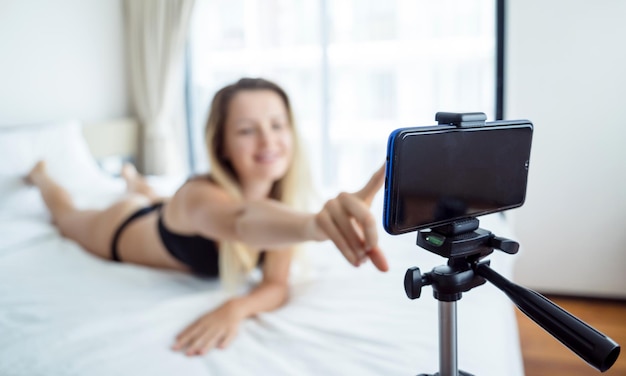 young sexy woman posing in front of camera and working as webcam model