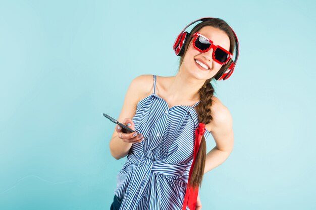 Young sexy woman with headphones and cellphone