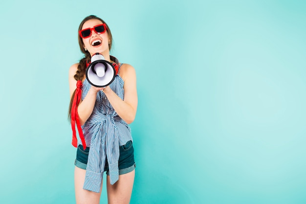 Young sexy woman with headphones and loudspeaker