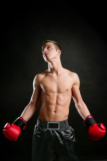 Young shaped man boxing