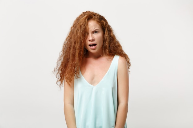 Young shocked irritated redhead woman girl in casual light clothes posing isolated on white background studio portrait. People sincere emotions lifestyle concept. Mock up copy space. Looking camera.