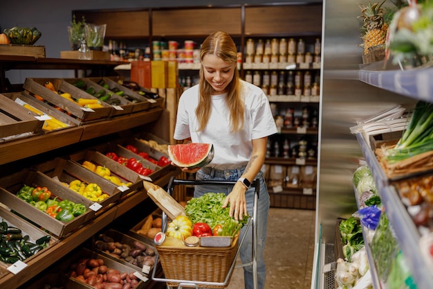 A Young Shopper Excitedly Picking Out Fresh Produce While Shopping in a Grocery Store