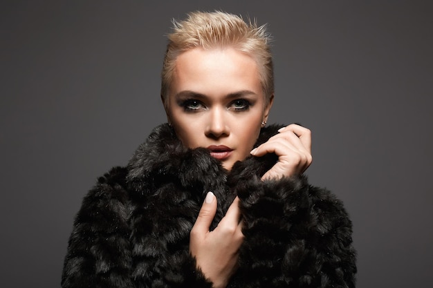 young short blond hair woman in fur beautiful girl