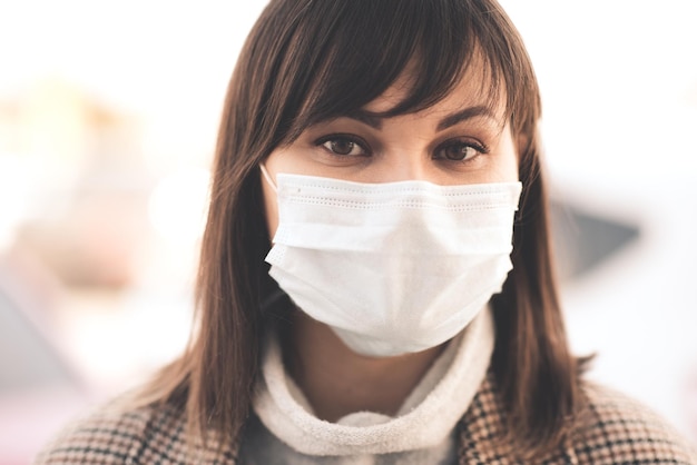 Young sick asian girl wearing medical mask outdoors