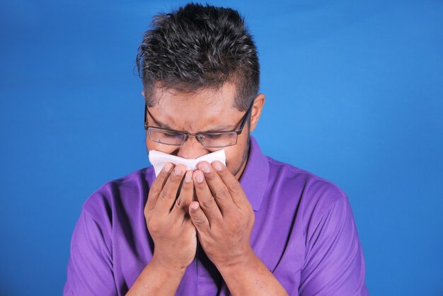 Young sick man in casual dress coughing ,