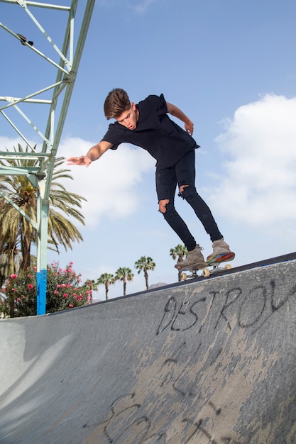 Young skateboarder performing tricks in a park.