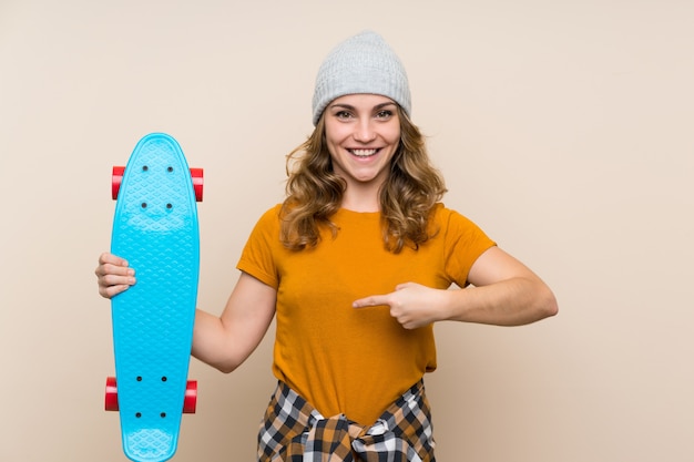 Young skater blonde girl and pointing it