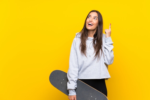 Young skater woman intending to realizes the solution while lifting a finger up