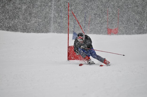 young skier race fast downhil at winter snow scene