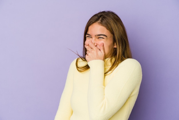 Young skinny caucasian girl teenager on purple space laughing happy, carefree, natural emotion.