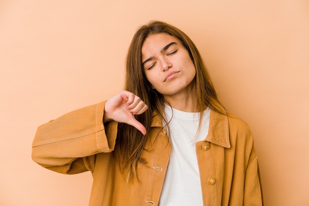 young skinny caucasian teenager girl showing a dislike gesture, thumbs down. disagreement concept.