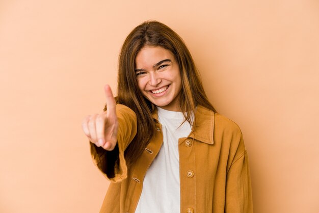 Young skinny caucasian teenager girl showing number one with finger.