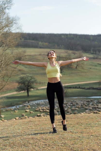 A young slim athletic girl in sportswear performs a set of exercises Fitness and healthy lifestyle