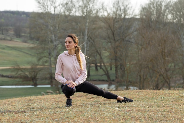 A young slim athletic girl in sportswear performs a set of exercises Fitness and healthy lifestyle