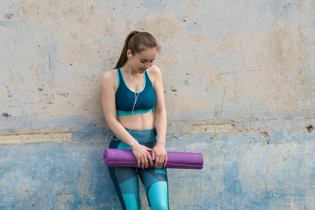 A young slim athletic girl in sportswear performs a set of exercises Fitness and healthy lifestyle