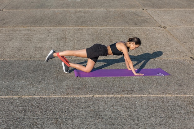 A young slim athletic girl in sportswear performs a set of exercises Fitness and healthy lifestyle