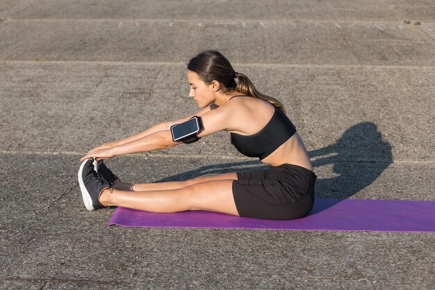 A young slim athletic girl in sportswear performs a set of exercises Fitness and healthy lifestyle