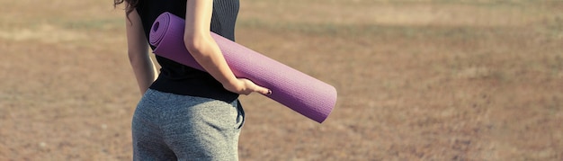 A young slim athletic girl in sportswear performs a set of exercises Fitness and healthy lifestyle