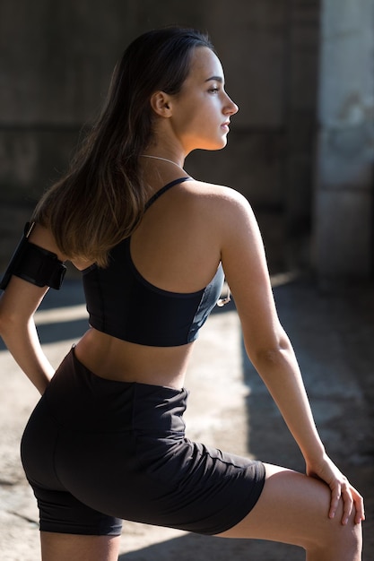 A young slim athletic girl in sportswear performs a set of exercises Fitness and healthy lifestyle