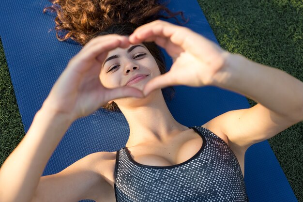 A young slim athletic girl in sportswear with snakeskin prints performs a set of exercises. Fitness and healthy lifestyle.