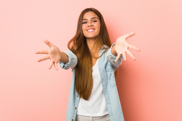 Young slim woman feels confident giving a hug 