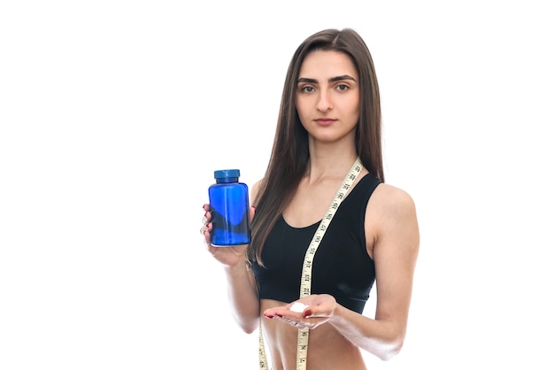 Young slim woman offering pills from bottle