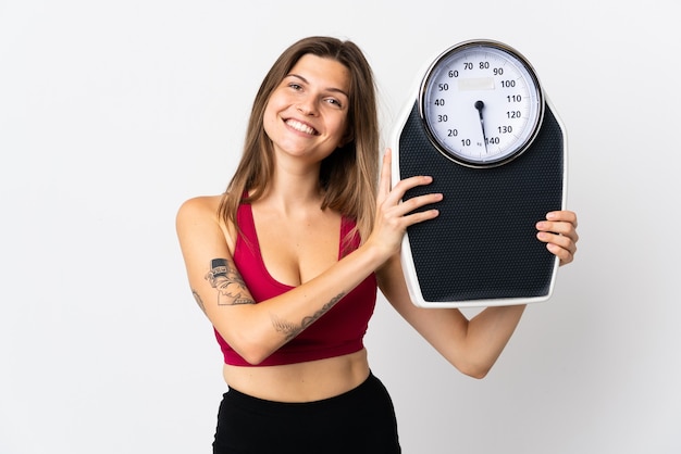 Young slovak woman isolated on white with weighing machine