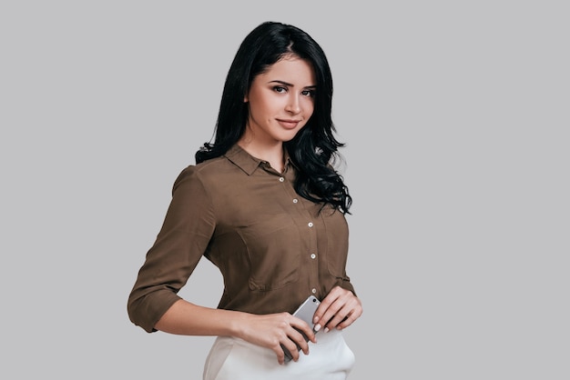 young and smart. attractive young woman in smart casual wear looking at camera and smiling 