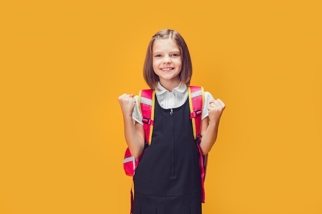 Young smart caucasian student girl wearing backpack standing over isolated yellow background screami.