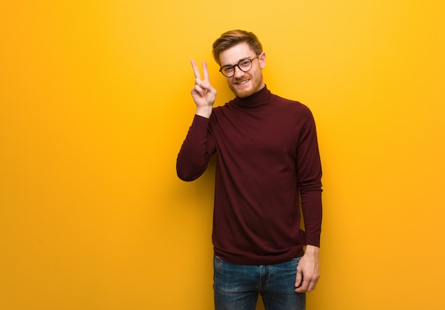 Young smart man fun and happy doing a gesture of victory