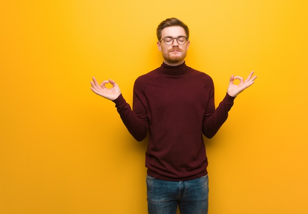 Young smart man performing yoga