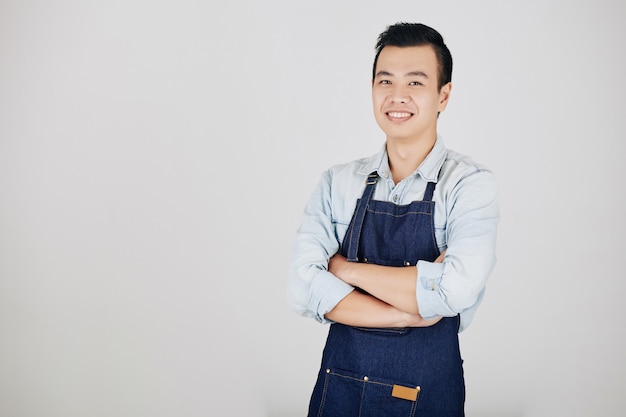 Young smiling Asian waiter